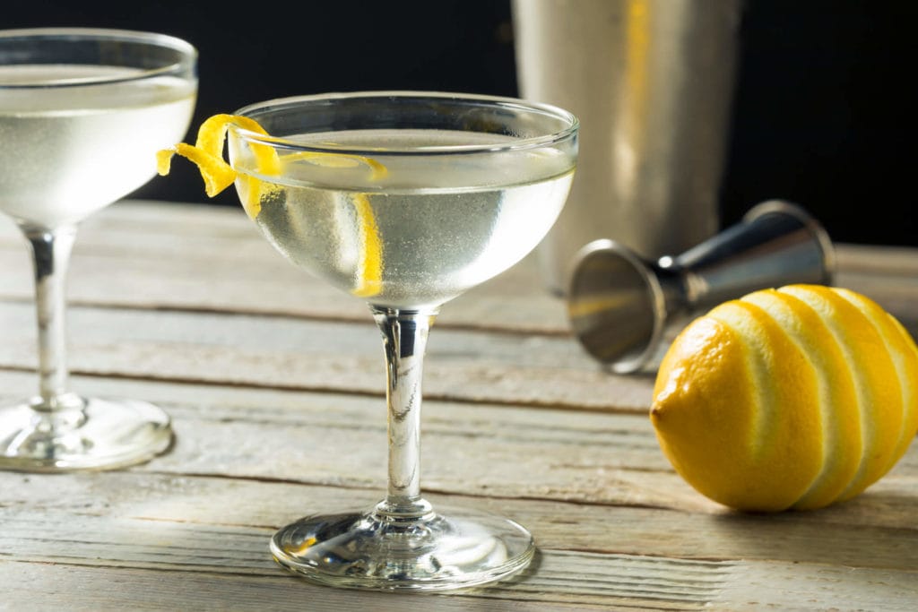 Photo of a cocktail with a lemon twist.