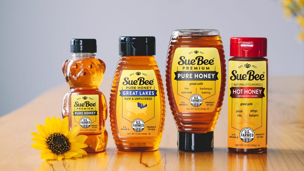 Bottles of SUE BEE® Honey, Hot Honey, and Regional Honey proudly displaying the new U.S. Farmed certification seal.