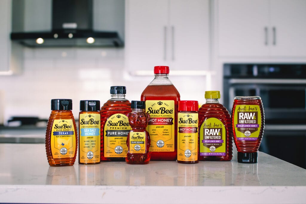 Line up of SUE BEE® and AUNT SUE'S® Honey bottles that are now U.S. Farmed certified.
